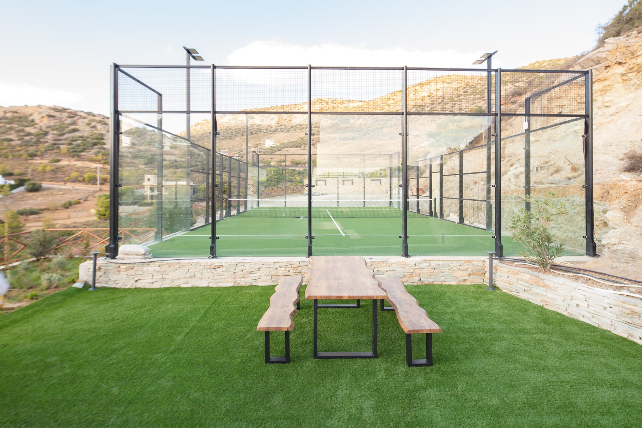 Private padel court at Villa Lithos with the mountains behind